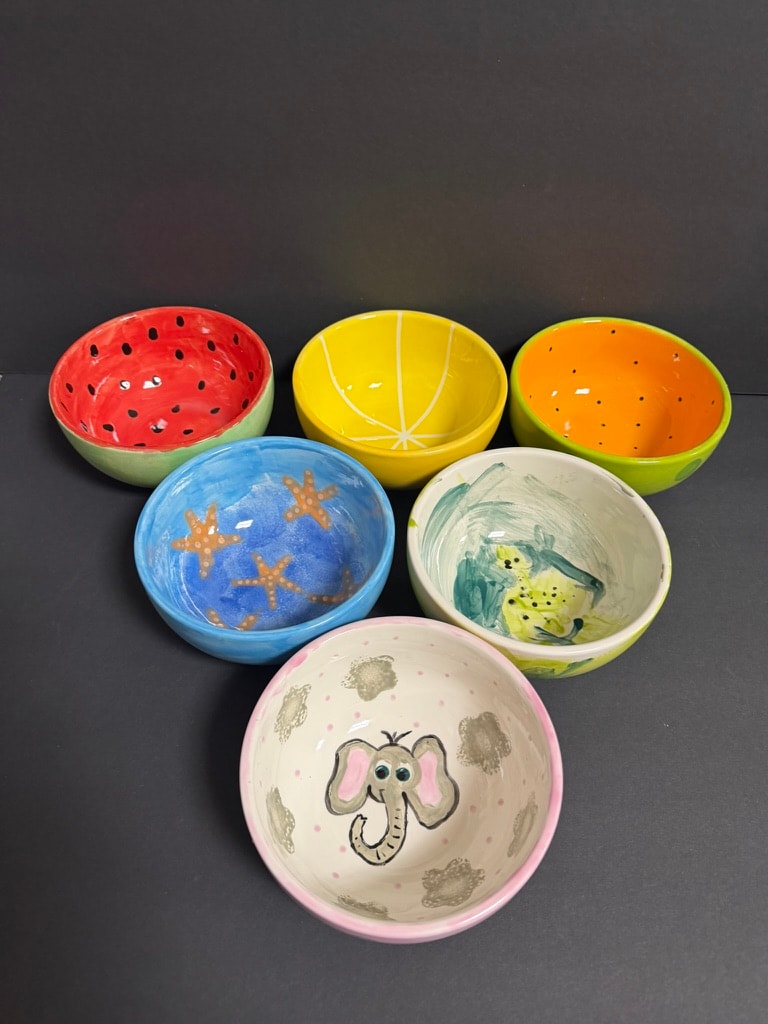 Colorful hand-painted ceramic bowls at Next of Kiln, LLC